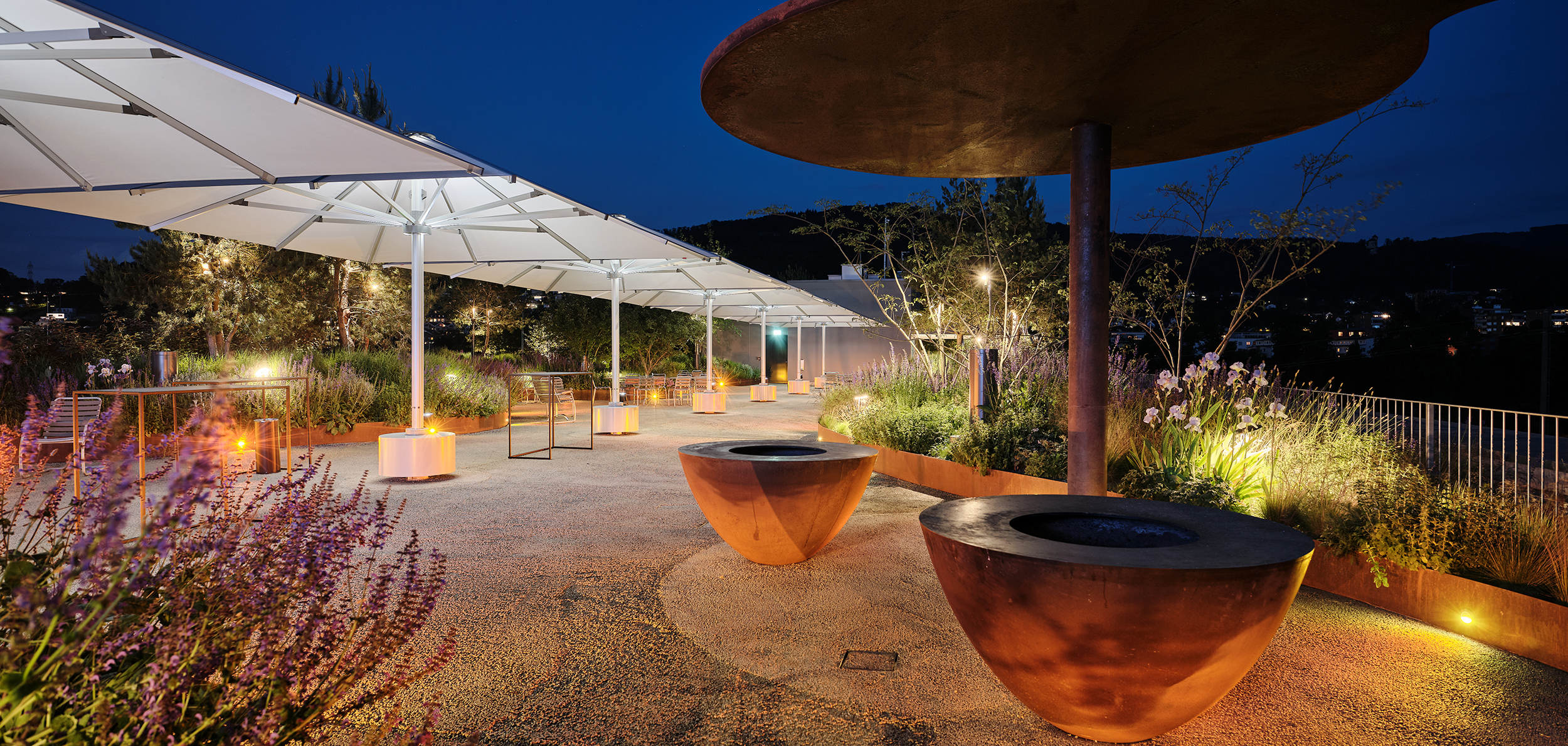 Rooftop garden on Building 1 of the uptownBasel campus with parasols and greenery
